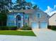 Charming brick home with a manicured lawn, mature trees, and a two-car garage at 7550 Star Magnolia, Lithonia, GA 30058