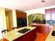 Open kitchen featuring a center island, granite countertops, and dark wood cabinets at 7550 Star Magnolia, Lithonia, GA 30058