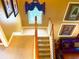 Carpeted staircase with wood banister leading to the upper level, brightly lit by the window at 7550 Star Magnolia, Lithonia, GA 30058