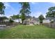 Large back yard with a well-maintained lawn, garden beds, and a fenced perimeter at 1130 Lochshyre Way, Lawrenceville, GA 30043