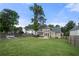 Expansive back yard featuring a large grass area, a patio, and garden beds at 1130 Lochshyre Way, Lawrenceville, GA 30043