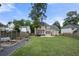 Expansive backyard with lush green lawn, garden beds, and a privacy fence around the property at 1130 Lochshyre Way, Lawrenceville, GA 30043