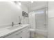 Bathroom featuring a vanity with drawers, a toilet, and a shower with vertical tiling at 1130 Lochshyre Way, Lawrenceville, GA 30043