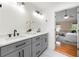 Bathroom featuring a double vanity with white countertops, gray cabinets, and black hardware at 1130 Lochshyre Way, Lawrenceville, GA 30043