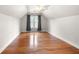 Attic bedroom featuring hardwood floors, a ceiling fan, and a large window at 1130 Lochshyre Way, Lawrenceville, GA 30043