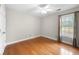 Bright bedroom with hardwood floors, a ceiling fan, a window, and a closet at 1130 Lochshyre Way, Lawrenceville, GA 30043