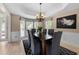 Elegant dining room with tray ceilings and large windows for natural light, seats six at 1130 Lochshyre Way, Lawrenceville, GA 30043