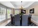 Elegant dining room with tray ceilings and large windows for natural light, seats six at 1130 Lochshyre Way, Lawrenceville, GA 30043