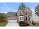 Beautiful brick two-story home with an attached garage and landscaped front yard at 1130 Lochshyre Way, Lawrenceville, GA 30043
