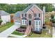 Charming two-story brick home with front-facing garage and manicured landscaping at 1130 Lochshyre Way, Lawrenceville, GA 30043