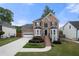 Charming two-story brick home with a well-manicured front lawn and attached two car garage at 1130 Lochshyre Way, Lawrenceville, GA 30043