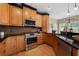 Modern kitchen featuring stainless steel appliances, custom cabinets and granite countertops at 1130 Lochshyre Way, Lawrenceville, GA 30043
