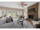 Living room with stone fireplace and backyard access at 1130 Lochshyre Way, Lawrenceville, GA 30043