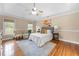Bright main bedroom with hardwood floors and tray ceiling at 1130 Lochshyre Way, Lawrenceville, GA 30043