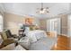 Main bedroom with tray ceiling, sitting area, and ensuite bathroom at 1130 Lochshyre Way, Lawrenceville, GA 30043