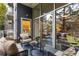 A cozy balcony with comfortable seating, a glass-topped table, and views of the surrounding greenery and bedroom inside at 130 Arizona Ne Ave # 104, Atlanta, GA 30307