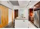 Kitchen island with granite countertop, stainless steel appliances, and access to a wood door at 130 Arizona Ne Ave # 104, Atlanta, GA 30307