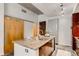 Kitchen island featuring granite countertop, stainless steel appliances, and adjacent wood and glass door at 130 Arizona Ne Ave # 104, Atlanta, GA 30307