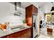 Bright kitchen with stainless steel appliances, granite counters, and modern vent hood at 130 Arizona Ne Ave # 104, Atlanta, GA 30307