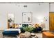 Cozy living room with a plush blue sofa, contemporary art, and decorative pillows at 130 Arizona Ne Ave # 104, Atlanta, GA 30307
