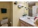 Well-lit bathroom with stylish vanity, framed mirror, and neutral tones ensures functionality at 1358 Stoneleigh Way, Stone Mountain, GA 30088