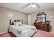 Comfortable bedroom with ornate headboard, dresser, and plush carpet, ideal for relaxation at 1358 Stoneleigh Way, Stone Mountain, GA 30088
