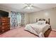 Cozy bedroom with floral border, plush carpet, and natural light creates a serene retreat at 1358 Stoneleigh Way, Stone Mountain, GA 30088