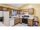 The kitchen is equipped with a gas oven, wooden cabinetry, and white countertops at 1358 Stoneleigh Way, Stone Mountain, GA 30088