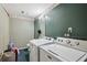 Functional laundry room with washer, dryer, and striped wallpaper for added practicality at 1358 Stoneleigh Way, Stone Mountain, GA 30088