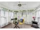 Bright sunroom with white curtains, a glass table, and decorative pillows, perfect for relaxation at 1358 Stoneleigh Way, Stone Mountain, GA 30088
