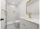 Modern bathroom with glass-enclosed shower, white tile, and elegant vanity at 2032 Spink Nw St, Atlanta, GA 30318