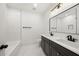 Modern bathroom with double vanity, bathtub, and tiled shower at 2032 Spink Nw St, Atlanta, GA 30318