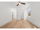A light and airy bedroom features hardwood floors, a ceiling fan, and a closet at 2032 Spink Nw St, Atlanta, GA 30318
