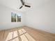 Sun-filled bedroom with hardwood floors, ceiling fan, and large window at 2032 Spink Nw St, Atlanta, GA 30318