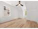 A bright bedroom with hardwood floors, fan, and natural light from two windows at 2032 Spink Nw St, Atlanta, GA 30318