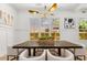 Bright dining room featuring a modern chandelier, a large table, and white chairs at 2032 Spink Nw St, Atlanta, GA 30318