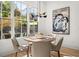 Light filled dining room with a round table and chairs with a view of the backyard at 2032 Spink Nw St, Atlanta, GA 30318