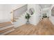 Bright foyer featuring hardwood floors, modern staircase, and an elegant plant at 2032 Spink Nw St, Atlanta, GA 30318