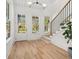 Inviting entryway with hardwood floors, staircase, and natural light streaming through large windows at 2032 Spink Nw St, Atlanta, GA 30318