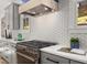 Gourmet kitchen featuring stainless steel appliances, gray cabinetry, and a stylish backsplash at 2032 Spink Nw St, Atlanta, GA 30318