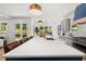 Open concept kitchen with a large island, stainless steel appliances, and seamless access to the backyard at 2032 Spink Nw St, Atlanta, GA 30318