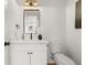 Stylish powder room with modern vanity, elegant mirror, and contemporary fixtures at 2032 Spink Nw St, Atlanta, GA 30318