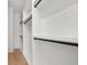 Spacious walk-in closet with custom shelving and ample storage space, all painted white at 2032 Spink Nw St, Atlanta, GA 30318