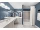 Stylish bathroom with dual sinks, white cabinetry, a large mirror, and a separate shower/tub area at 3334 Peachtree Ne Rd # 608, Atlanta, GA 30326