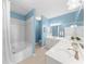 Stylish bathroom featuring dual sinks, a large mirror, white cabinetry, and a separate tub/shower area at 3334 Peachtree Ne Rd # 608, Atlanta, GA 30326