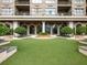Building exterior with large arches, trimmed bushes, a fountain, and an artificial lawn at 3334 Peachtree Ne Rd # 608, Atlanta, GA 30326