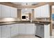 Well-lit kitchen with stainless steel appliances, granite countertops and white cabinets at 3334 Peachtree Ne Rd # 608, Atlanta, GA 30326