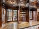 Beautiful library with dark wood trim, hardwood floors, french doors, a loft, and built in bookshelves at 3334 Peachtree Ne Rd # 608, Atlanta, GA 30326
