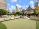 Outdoor community area with putting green, grill, and skyline view at 3334 Peachtree Ne Rd # 608, Atlanta, GA 30326