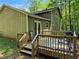 View of the deck featuring outdoor furniture, perfect for relaxing or entertaining surrounded by mature trees at 3832 Natalie Way, Ellenwood, GA 30294